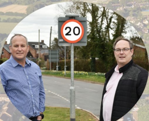 Mike Rigby and Andy Sully standing next to a 20mph sign